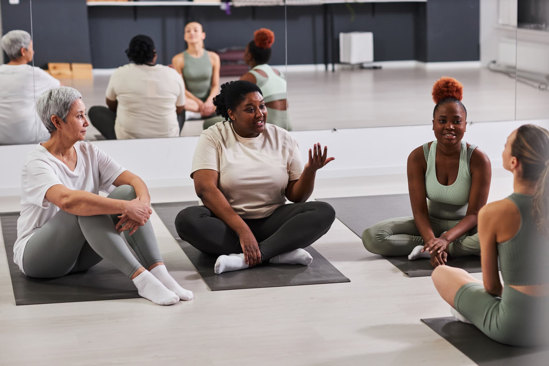 Members talking and laughing together after a class at the studio